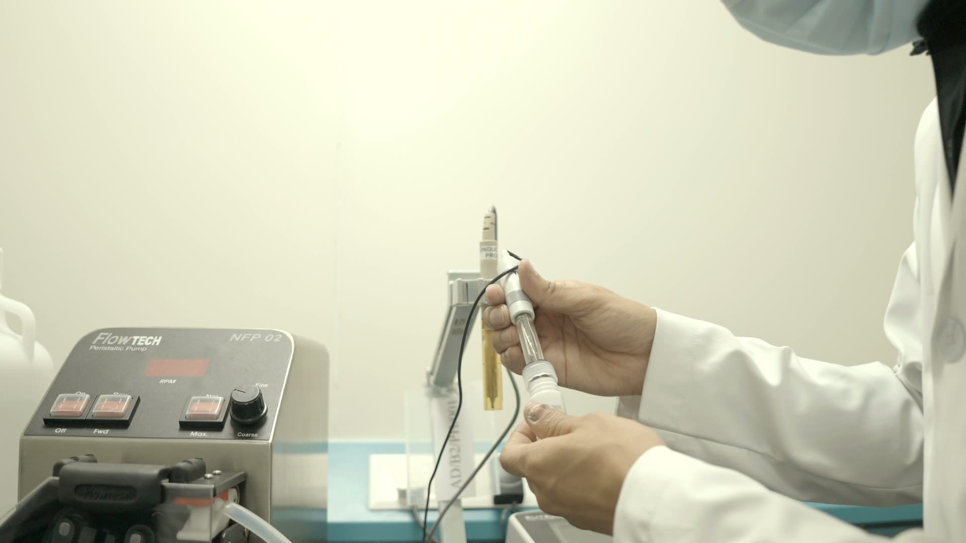 Scientist with a peristaltic pump